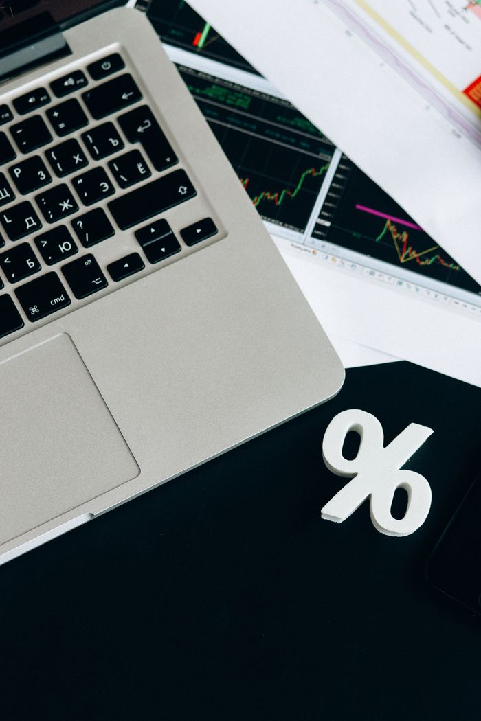 Crafting Captivating Headlines: Your awesome post title goes here Close-up of a laptop keyboard with percentage symbol, representing financial analysis and investment concepts.